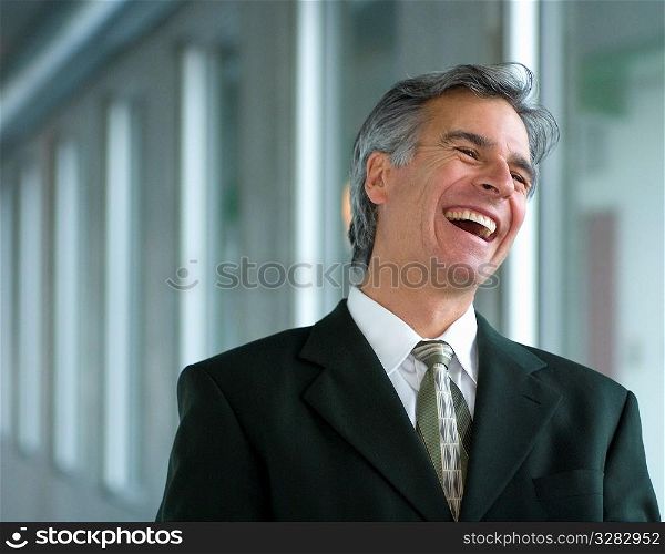 Businessman laughing out loud.