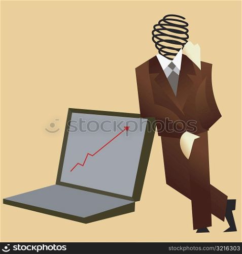 Businessman leaning against a laptop computer