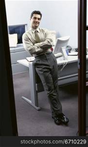 Businessman leaning on a desk