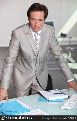 businessman leaning on table