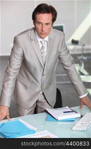businessman leaning on table