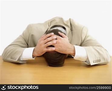 Businessman leaning with his head on the table