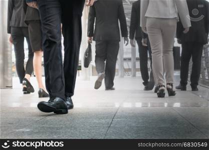 businessman legs walking go forward as outstanding by other legs walking as opposite direction on business street