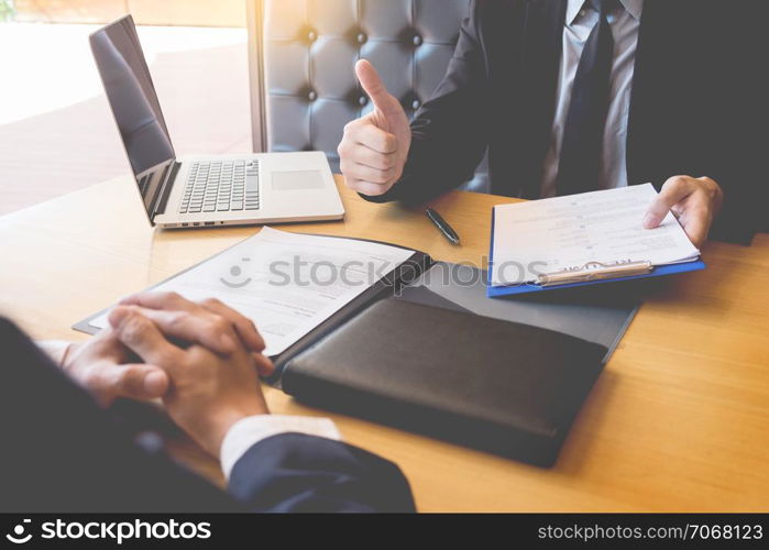 businessman listen to young attractive man explaining about his profile candidate interview answers