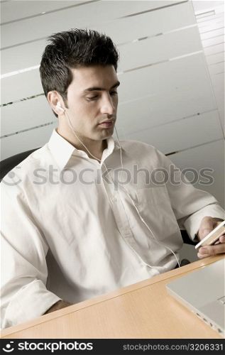 Businessman listening to an MP3 Player