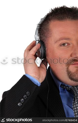 Businessman listening to headphones