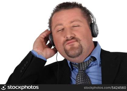 Businessman listening to music