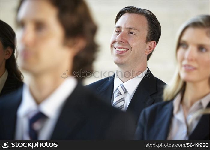 Businessman Listening To Speaker At Conference