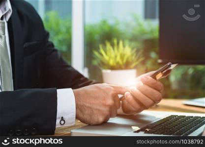 Businessman login mobile smart phone working with computer laptop