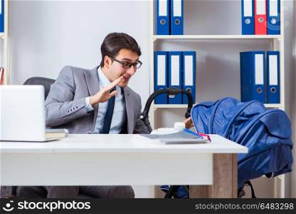 Businessman looking after newborn baby in office