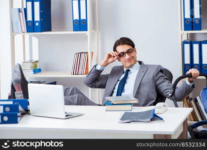 Businessman looking after newborn baby in office