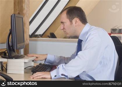 Businessman looking at a computer monitor