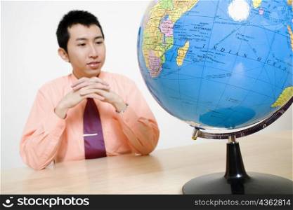 Businessman looking at a globe