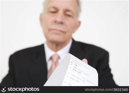 Businessman Looking at Calculator Paper