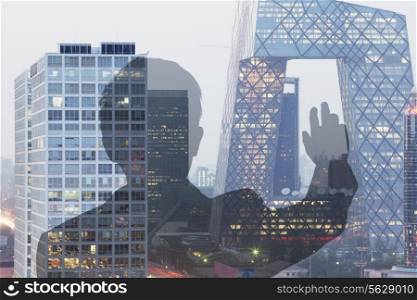Businessman looking at CCTV building in Beijing, Double exposure
