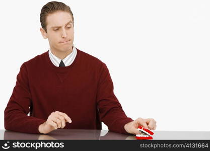 Businessman looking at dentures and thinking