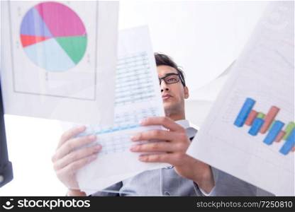 Businessman looking at financial charts and graphs