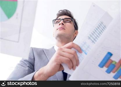 Businessman looking at financial charts and graphs. The businessman looking at financial charts and graphs