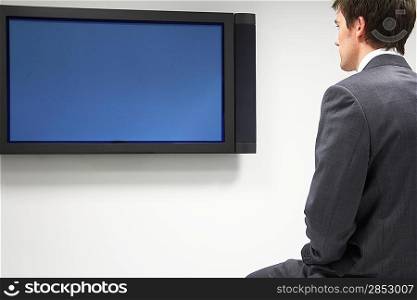 Businessman Looking at Flat Panel Television
