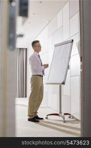 Businessman looking at flipchart in office