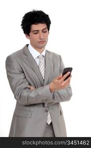 Businessman looking at his cellphone