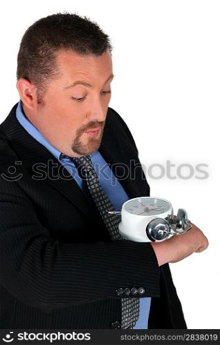 businessman looking at his enormous hand watch