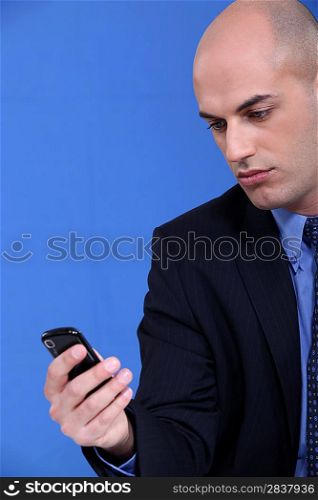 Businessman looking at his mobile phone