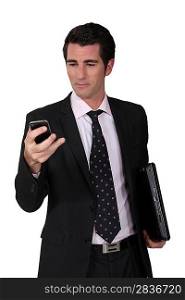 Businessman looking at his phone.