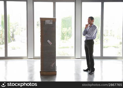 Businessman Looking at Large Package