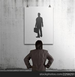 businessman looking at people icon on art frame on the wall as human resources concept