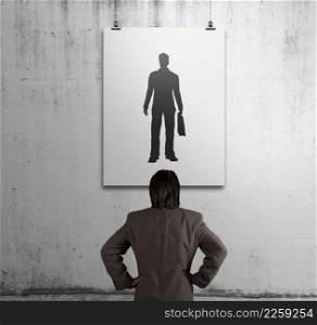 businessman looking at people icon on art frame on the wall as human resources concept