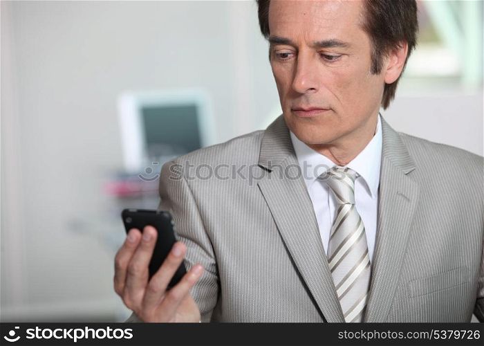 Businessman looking at phone