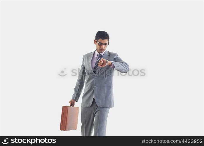 Businessman looking at watch