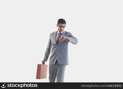 Businessman looking at watch