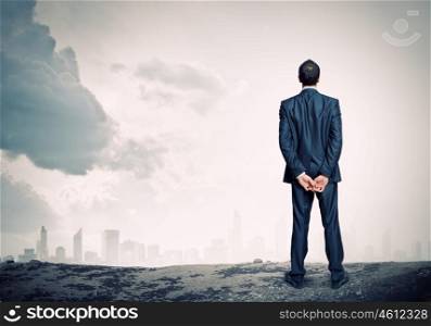Businessman looking forward. Rear view of businessman looking into distance