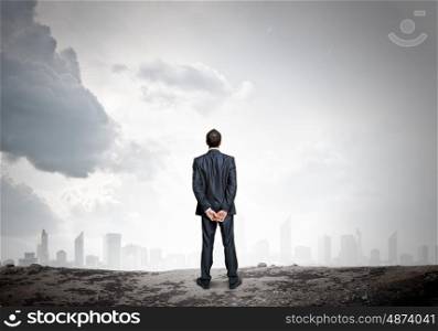 Businessman looking forward. Rear view of businessman looking into distance