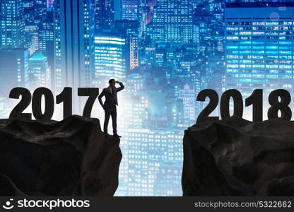 Businessman looking forward to 2018 from 2017. The businessman looking forward to 2018 from 2017