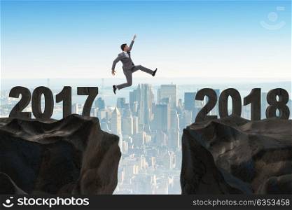 Businessman looking forward to 2018 from 2017. The businessman looking forward to 2018 from 2017