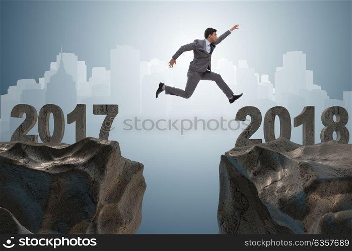 Businessman looking forward to 2018 from 2017. The businessman looking forward to 2018 from 2017