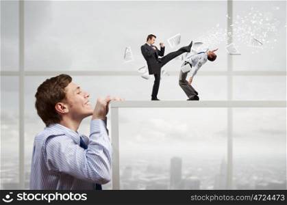 Businessman looking from under table at two fighting colleagues