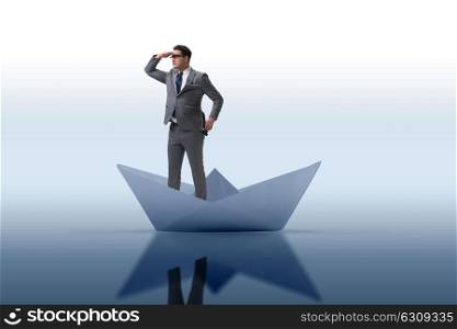 Businessman looking into future with binoculars in paper ship boat. Businessman looking into future with binoculars in paper ship bo
