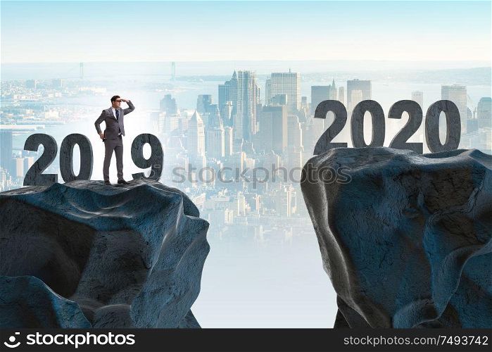 Businessman looking into the future 2020 from 2019. Businessman looking into future 2020 from 2019