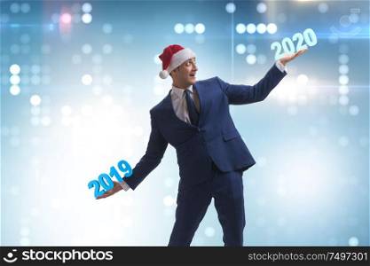 Businessman looking into the future 2020 from 2019. Businessman looking into future 2020 from 2019
