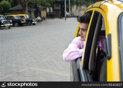 Businessman looking out of a taxi