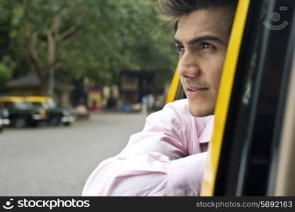 Businessman looking out of a taxi