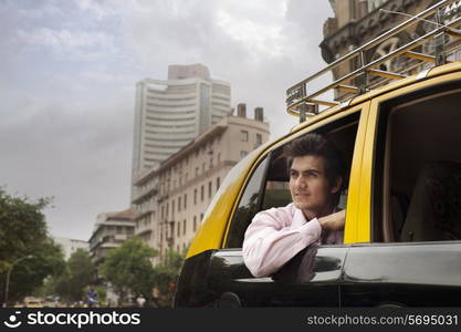 Businessman looking out of a taxi