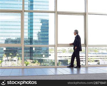 Businessman looking out of office window