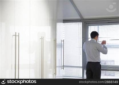 Businessman Looking out Window