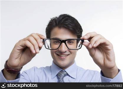 Businessman looking through spectacles