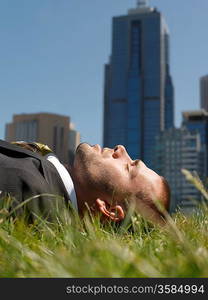 Businessman Lying in City Park